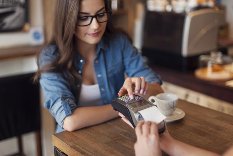 A customer makes a payment at a cafe.