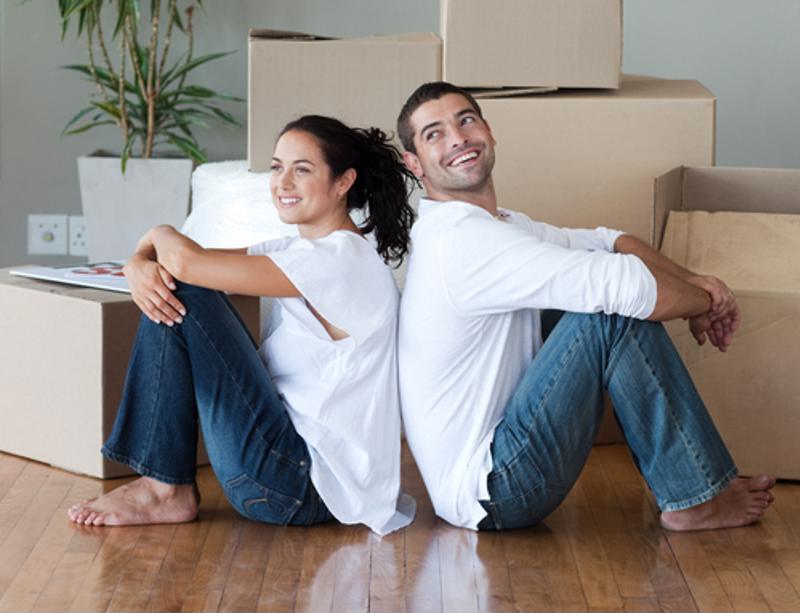 Happy young couple moving house.